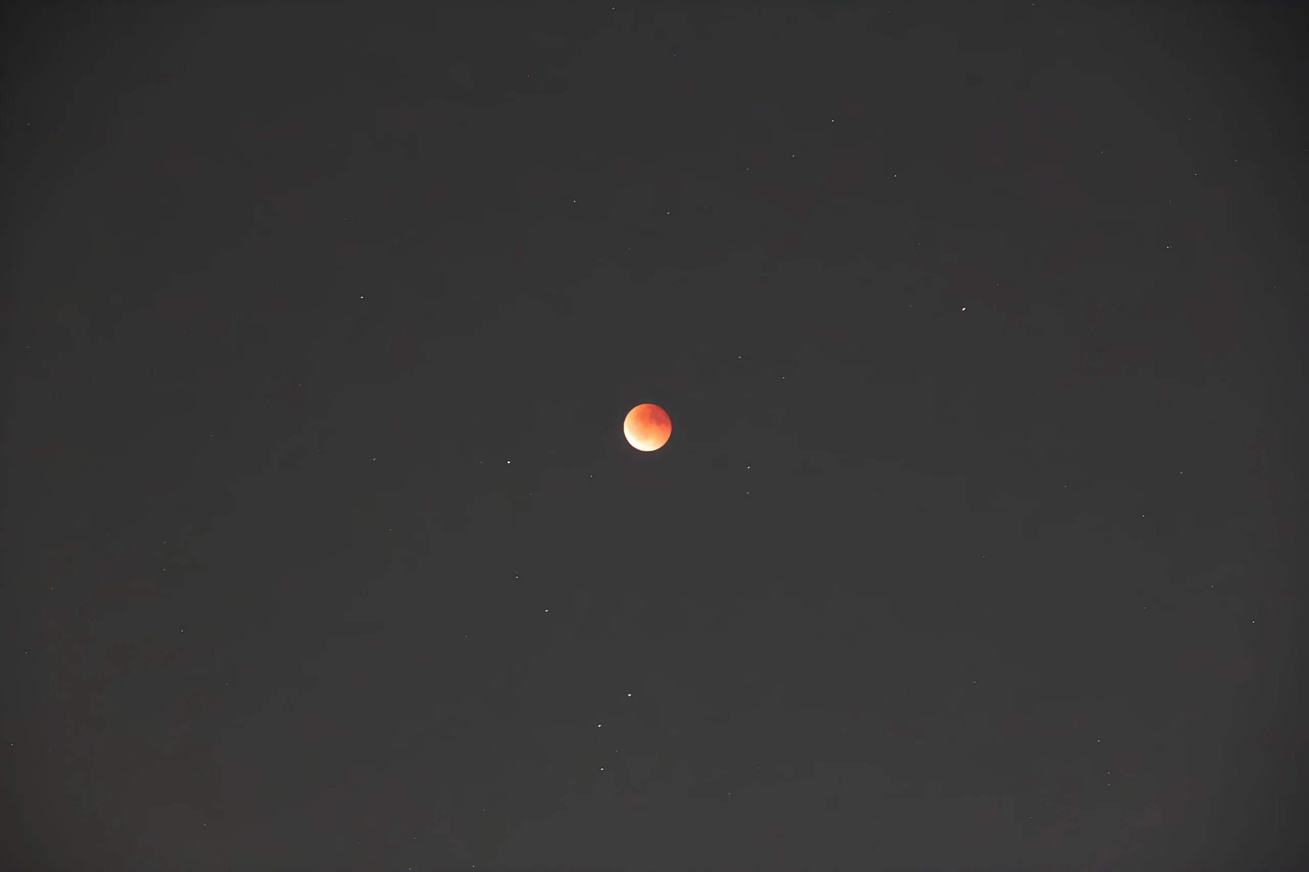 Blood Moon lunar eclipse under hazy urban sky